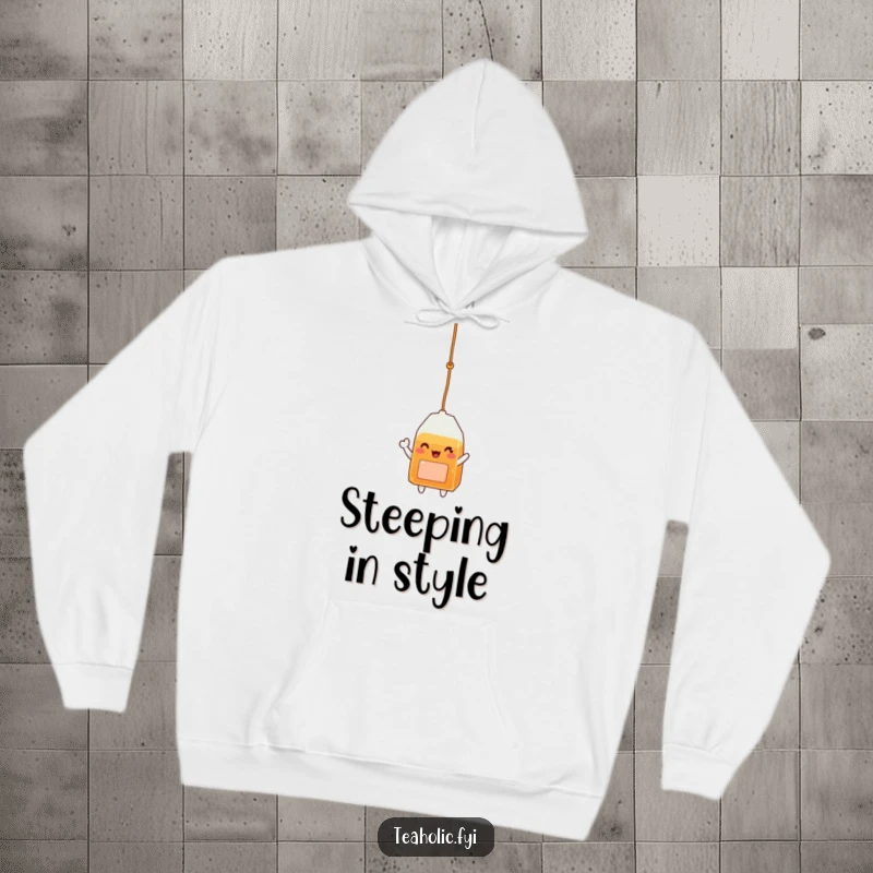 Funny hoodie featuring a cheerful tea bag character, dangling from a string and waving hello, perfect for cozy, happy days.